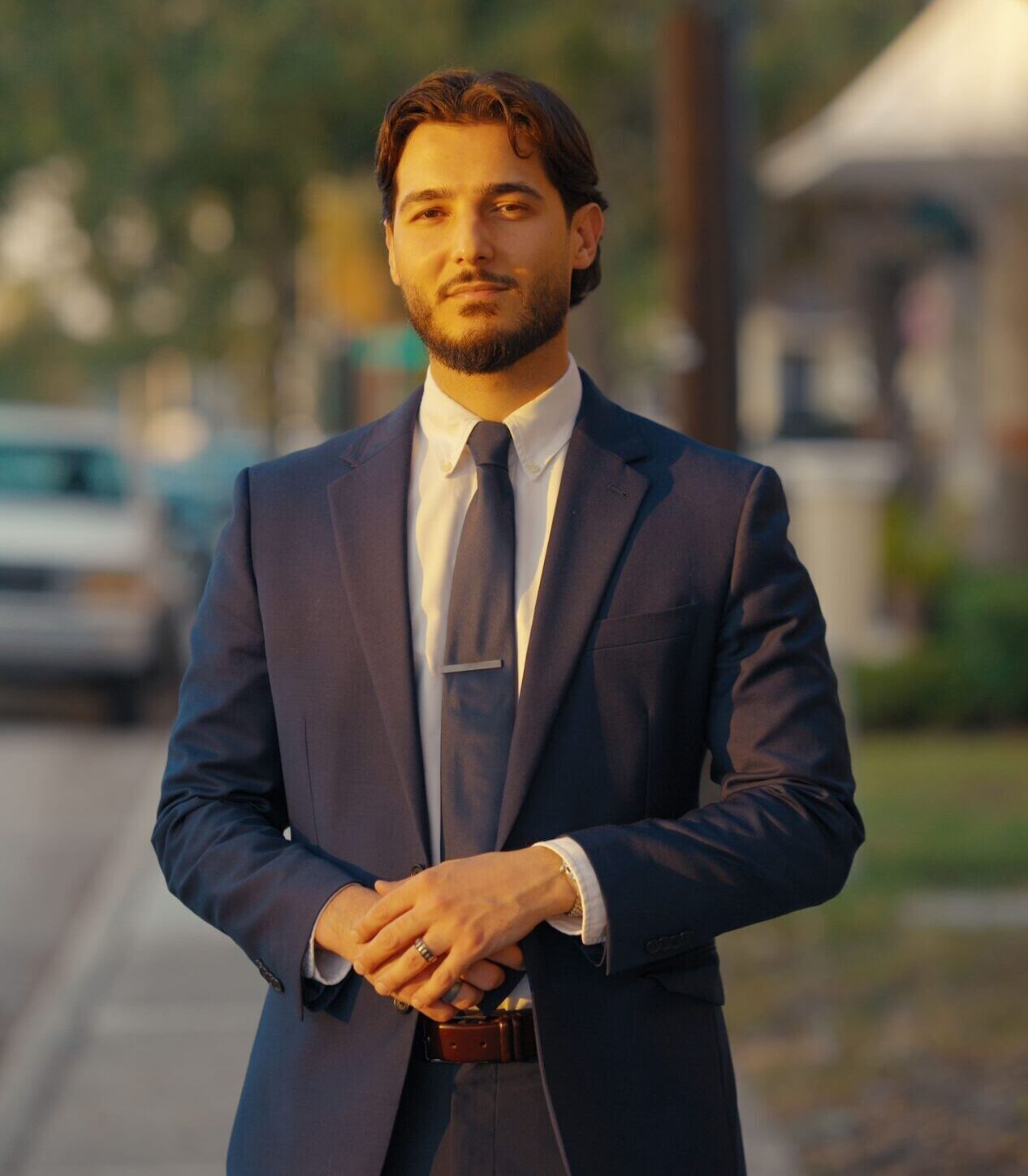 Portrait of attorney Omar Erchid in a navy suit and tie, outdoors, conveying a formal, professional look for the Erchid Law Firm in the Tampa Bay area.